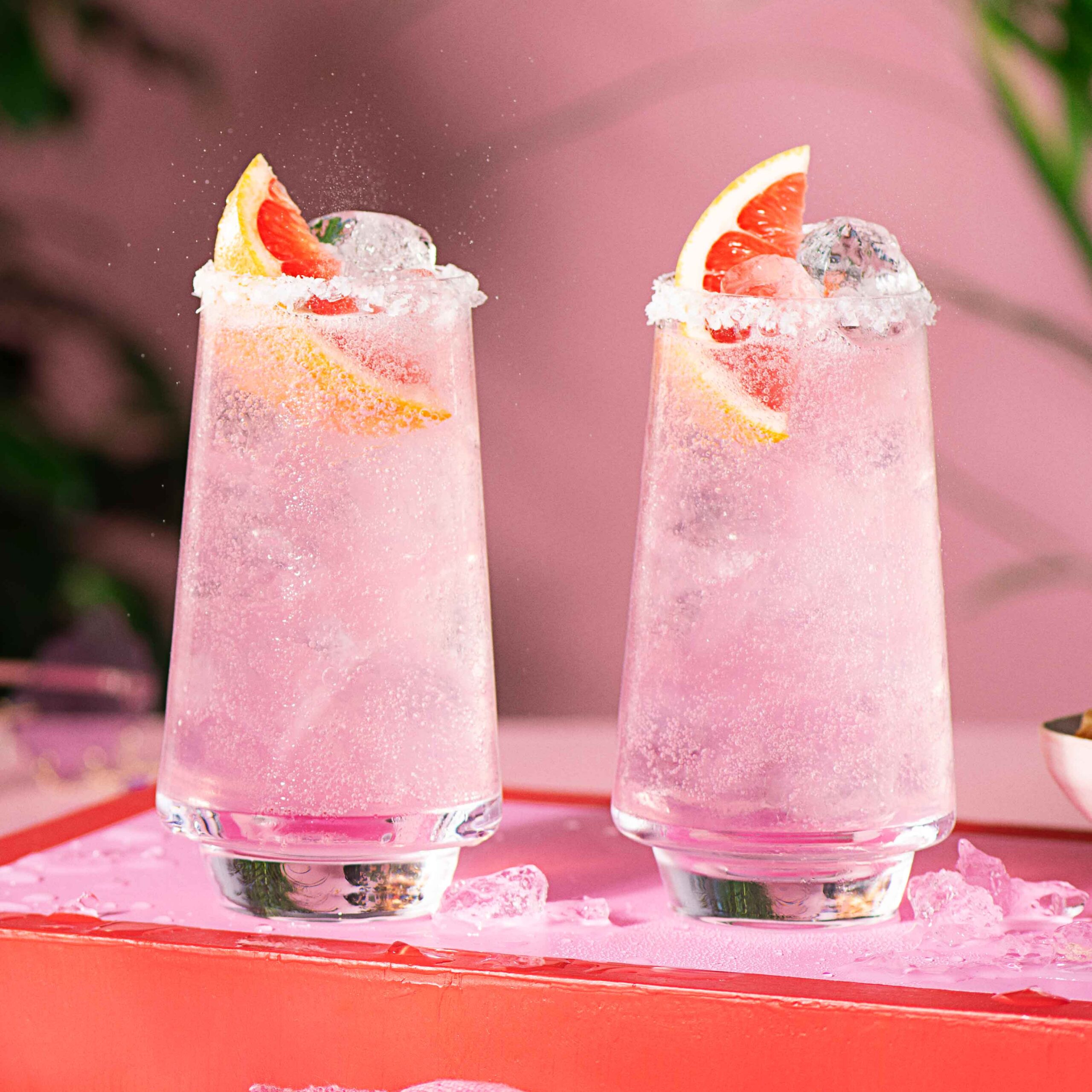 Two pink malibu Palomas in a highball glass