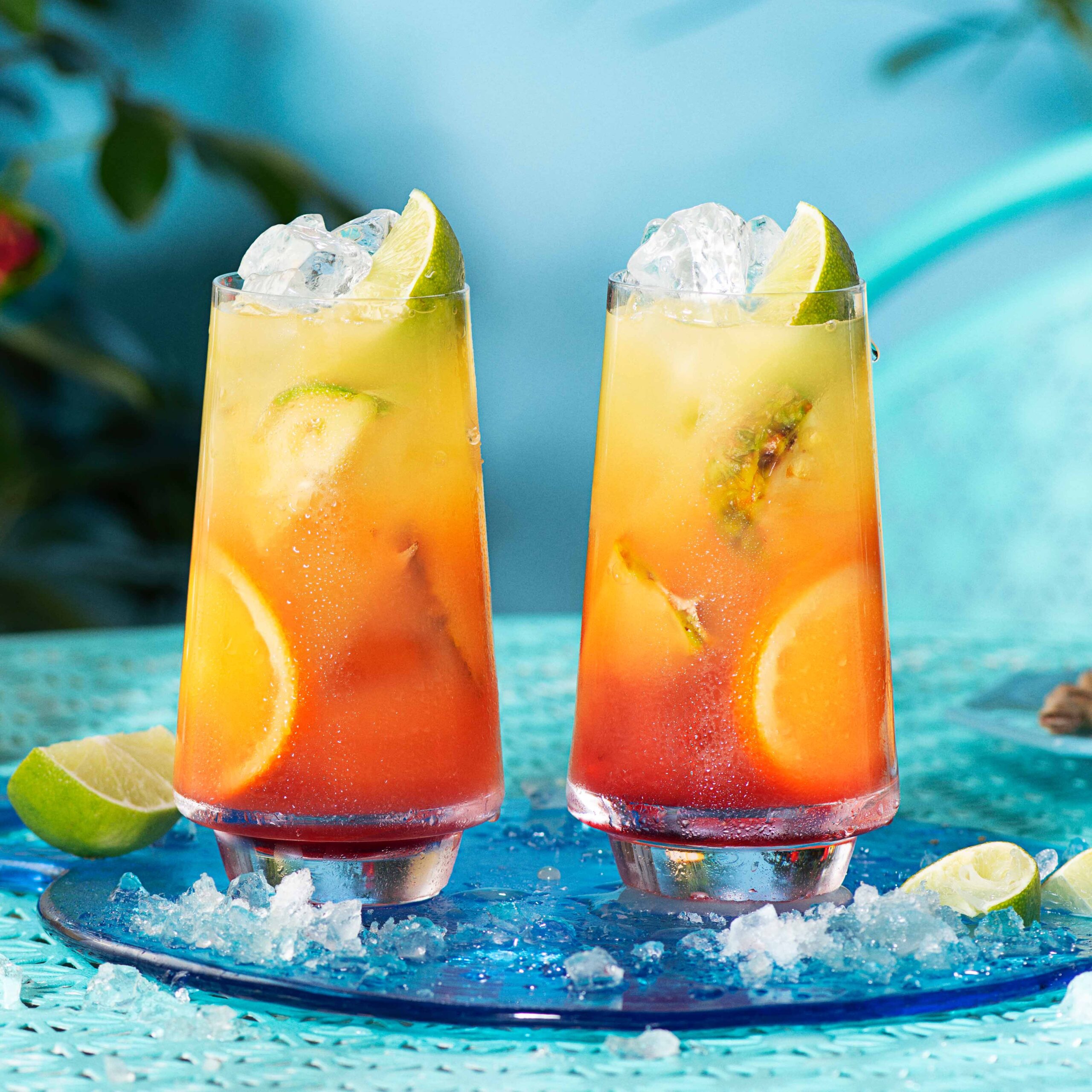 2 Malibu Sunrises on a serving tray against a blue background