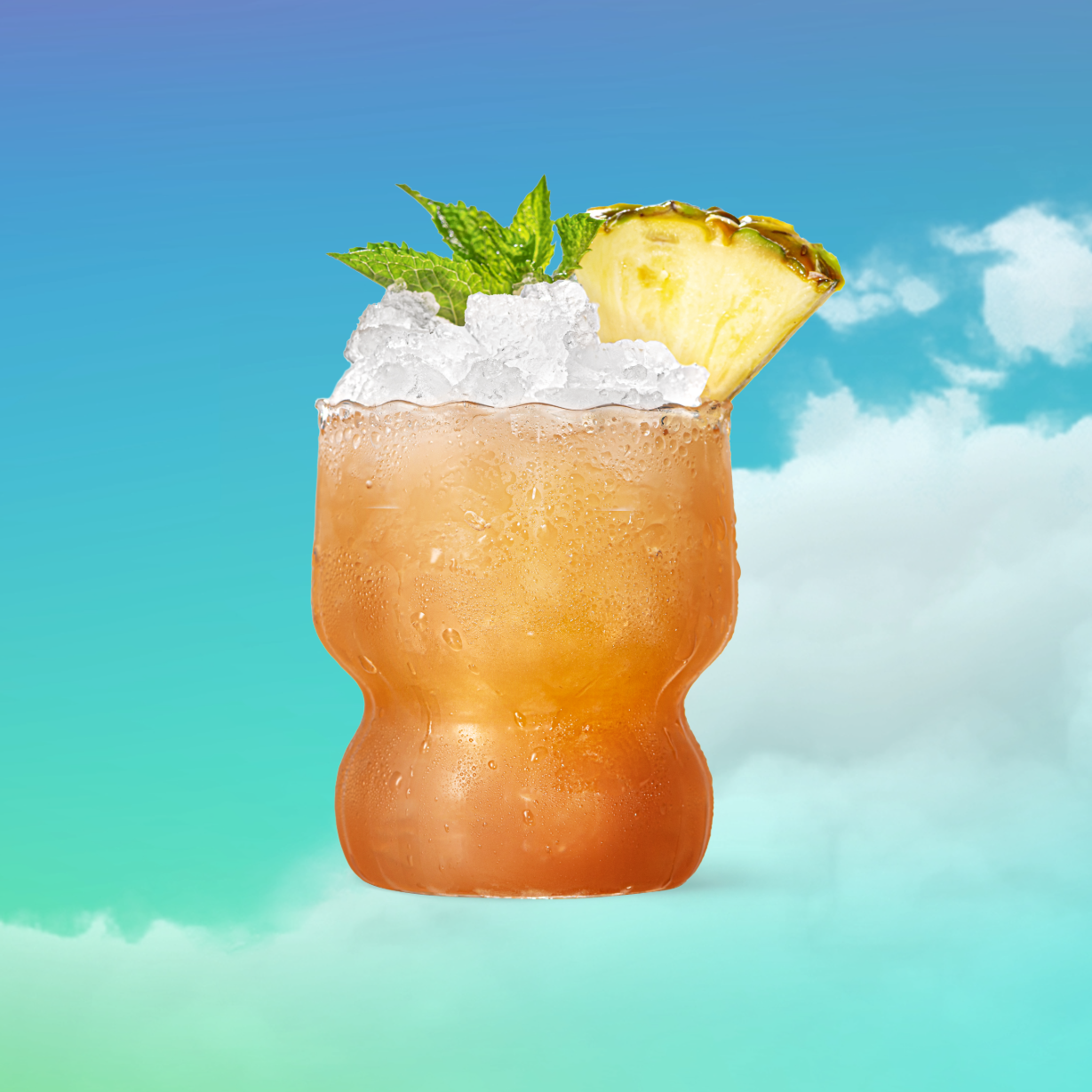 Malibu Black Bahama Mama garnished with a pineapple wedge and mint sprig in front of a blue cloudy background.